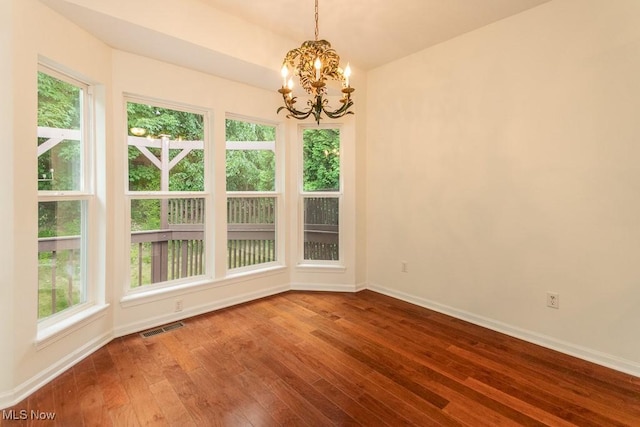 583 Mock Orange Cir, Chagrin Falls, OH 44023 - unfurnished room featuring a chandelier, healthy amount of natural light, and wood-type flooring