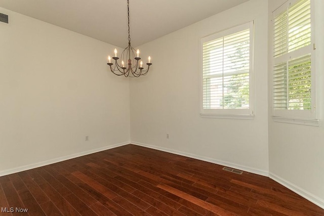 583 Mock Orange Cir, Chagrin Falls, OH 44023 - unfurnished room featuring dark wood-style flooring and a chandelier