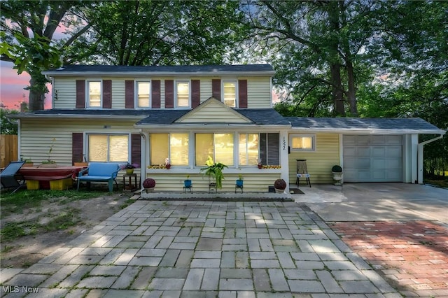 1552 E 254th St, Euclid, OH 44117 - rear view of property with decorative driveway and an attached garage
