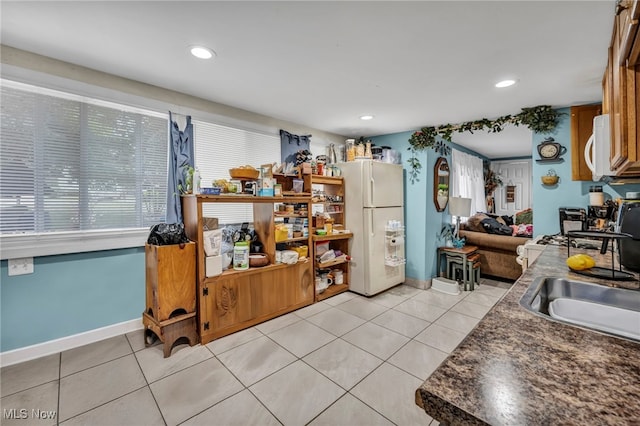 1552 E 254th St, Euclid, OH 44117 - kitchen with white appliances, dark countertops, light tile patterned floors, and recessed lighting