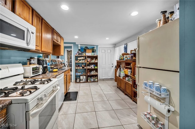 1552 E 254th St, Euclid, OH 44117 - kitchen featuring white appliances, recessed lighting, light tile patterned flooring, and brown cabinetry