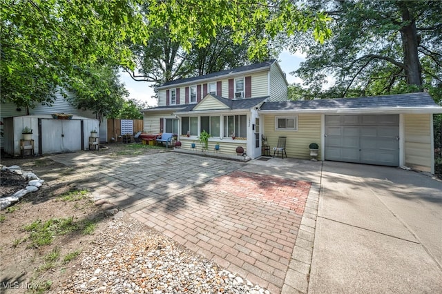 1552 E 254th St, Euclid, OH 44117 - traditional-style home featuring driveway, a garage, and a storage unit