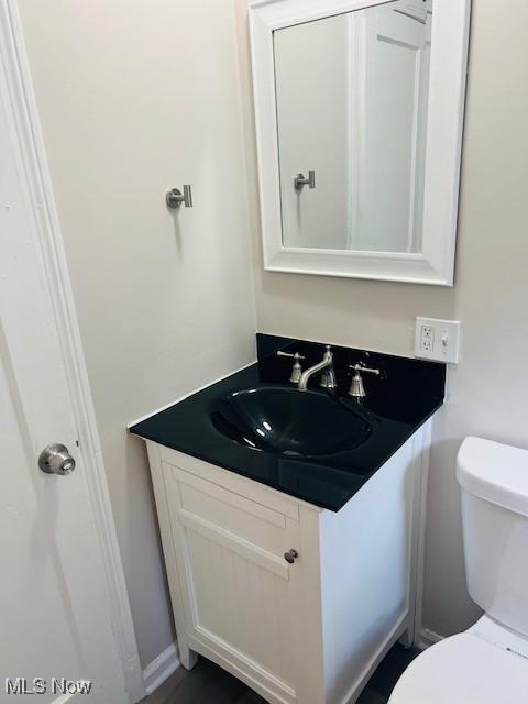 1700 Malasia Rd, Akron, OH 44305 - half bath featuring vanity and toilet