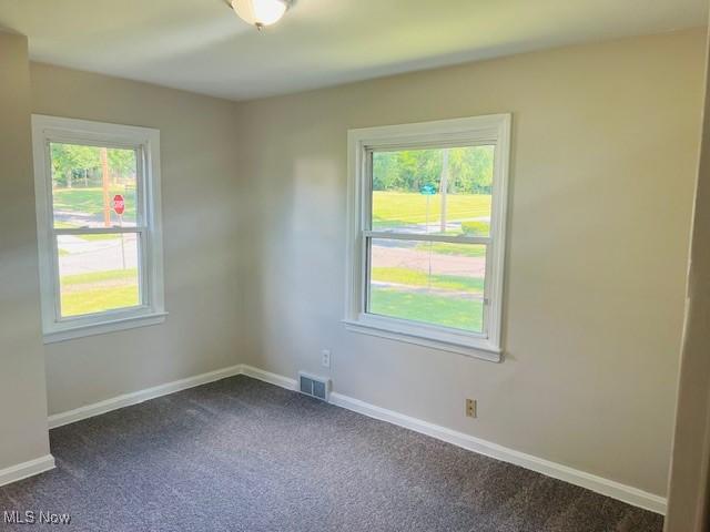 1700 Malasia Rd, Akron, OH 44305 - empty room featuring dark carpet and baseboards