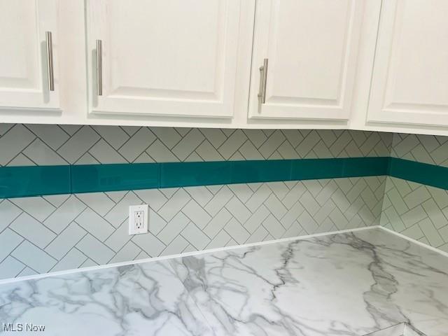1700 Malasia Rd, Akron, OH 44305 - detailed view of white cabinetry and light stone countertops