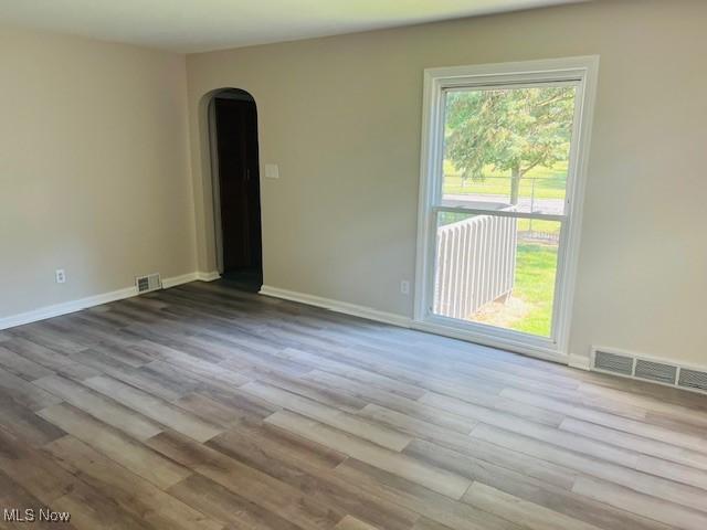 1700 Malasia Rd, Akron, OH 44305 - empty room featuring arched walkways and wood finished floors