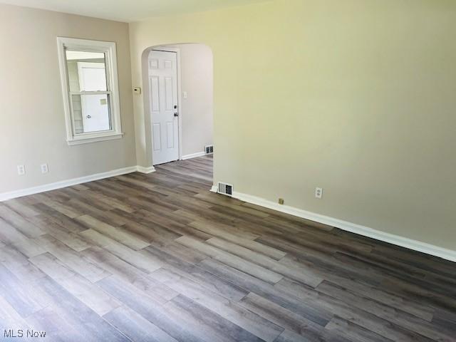 1700 Malasia Rd, Akron, OH 44305 - unfurnished room with arched walkways and dark wood finished floors
