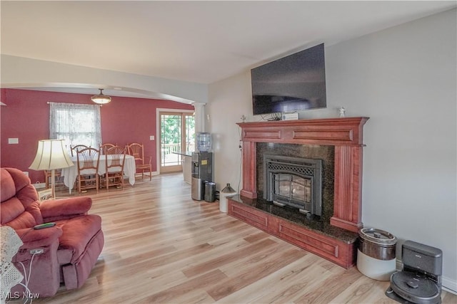 2077 Daniels Ave, Akron, OH 44312 - living area with light wood finished floors, arched walkways, decorative columns, and a high end fireplace