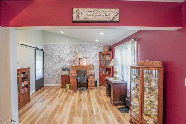 2077 Daniels Ave, Akron, OH 44312 - home office with vaulted ceiling, wood finished floors, a barn door, an accent wall, and recessed lighting