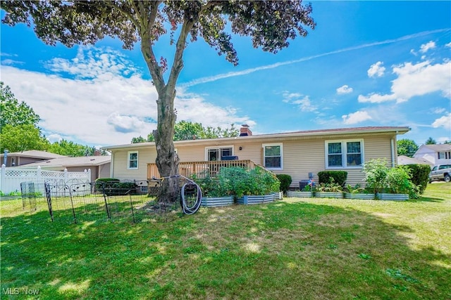 2077 Daniels Ave, Akron, OH 44312 - rear view of house with a vegetable garden