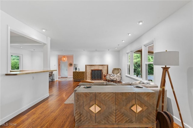 1332 Broadview Ave, Akron, OH 44321 - living area featuring wood finished floors, plenty of natural light, and a tile fireplace