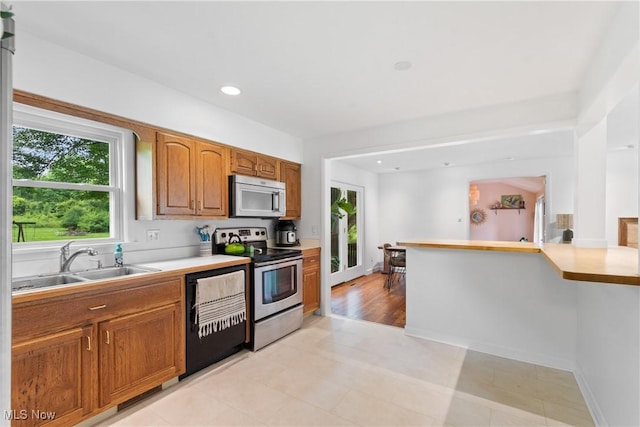 1332 Broadview Ave, Akron, OH 44321 - kitchen with stainless steel appliances, light countertops, brown cabinets, and recessed lighting