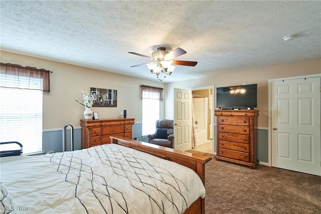 bedroom with carpet floors, a textured ceiling, and ceiling fan