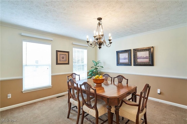 dining space with a chandelier, carpet flooring, ornamental molding, and a textured ceiling