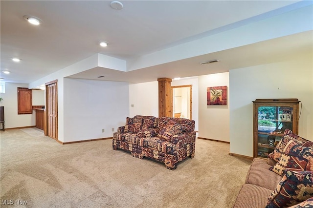 living area featuring light colored carpet and recessed lighting