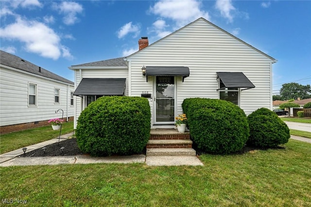 908 Dawnwood Dr, Parma, OH 44134 - view of front of property with a front yard and a chimney