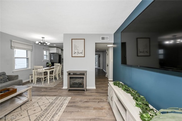 908 Dawnwood Dr, Parma, OH 44134 - living area featuring a chandelier and light wood-style flooring