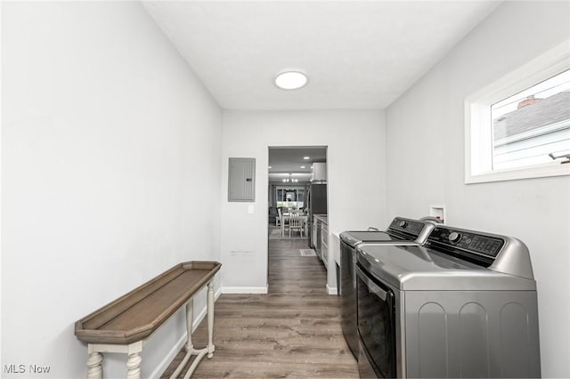 908 Dawnwood Dr, Parma, OH 44134 - laundry area featuring washing machine and clothes dryer, wood finished floors, electric panel, and healthy amount of natural light