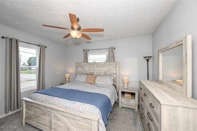 908 Dawnwood Dr, Parma, OH 44134 - bedroom featuring light colored carpet, multiple windows, a textured ceiling, and ceiling fan