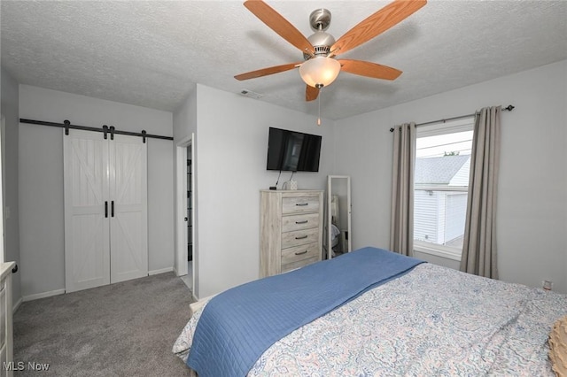 908 Dawnwood Dr, Parma, OH 44134 - bedroom with a barn door, carpet, a textured ceiling, and ceiling fan