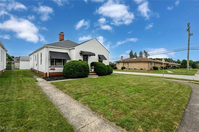 908 Dawnwood Dr, Parma, OH 44134 - view of front of property featuring a chimney, a shingled roof, and a front yard