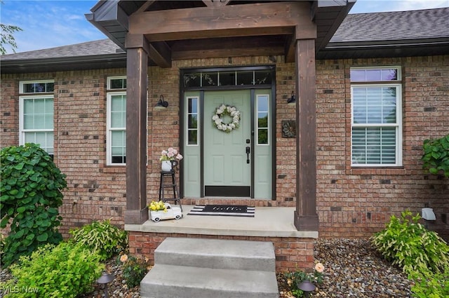 5461 Brook Run Ave NE, Louisville, OH 44641 - view of exterior entry with a shingled roof and brick siding