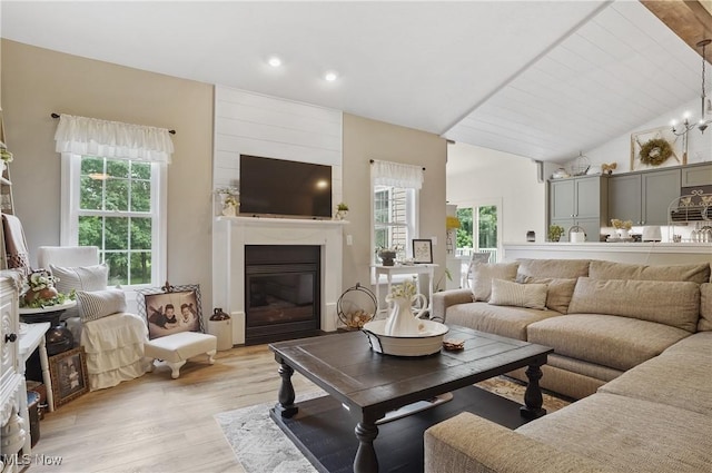 5461 Brook Run Ave NE, Louisville, OH 44641 - living area featuring light wood finished floors, a fireplace, recessed lighting, and high vaulted ceiling