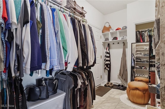 5461 Brook Run Ave NE, Louisville, OH 44641 - walk in closet featuring marble look tile flooring