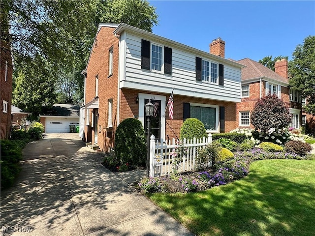 130 E 199th St, Euclid, OH 44119 - view of front of home with brick siding, an outbuilding, a chimney, and a garage