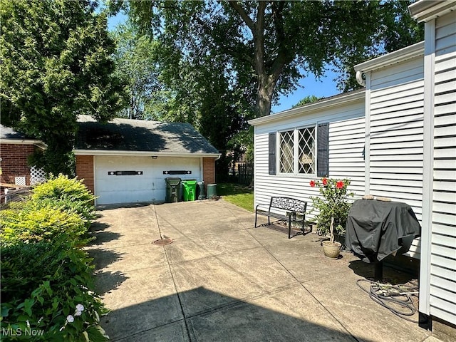 130 E 199th St, Euclid, OH 44119 - view of patio / terrace with a garage, an outbuilding, and a grill