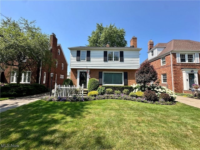 130 E 199th St, Euclid, OH 44119 - colonial home featuring a front lawn and brick siding