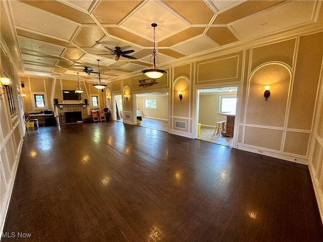 130 E 199th St, Euclid, OH 44119 - unfurnished living room featuring a decorative wall, ceiling fan, a fireplace, healthy amount of natural light, and wood finished floors