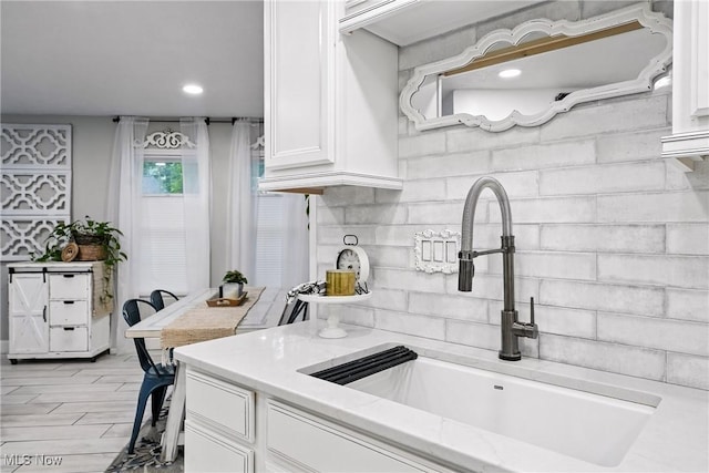 1293 Redtail Hawk Dr Unit 4, Boardman, OH 44512 - kitchen featuring white cabinetry, light stone counters, recessed lighting, and tasteful backsplash