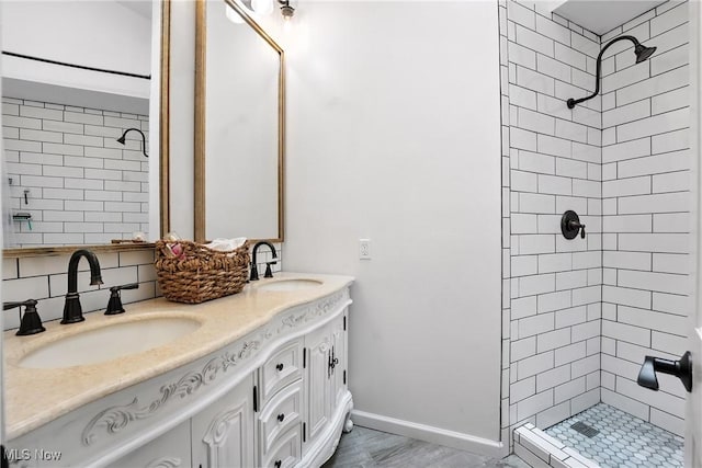 1293 Redtail Hawk Dr Unit 4, Boardman, OH 44512 - bathroom featuring a tile shower, double vanity, and tasteful backsplash