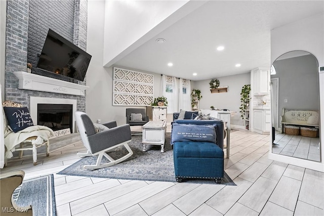 1293 Redtail Hawk Dr Unit 4, Boardman, OH 44512 - living room with a fireplace, recessed lighting, wood tiled floors, and arched walkways