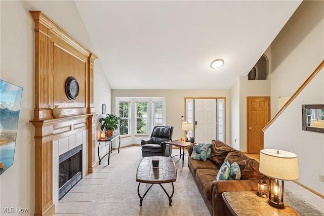 957 Devonwood Dr, Wadsworth, OH 44281 - living area featuring lofted ceiling, a tiled fireplace, and light carpet