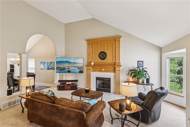 957 Devonwood Dr, Wadsworth, OH 44281 - living room featuring vaulted ceiling, a tiled fireplace, light colored carpet, and a chandelier