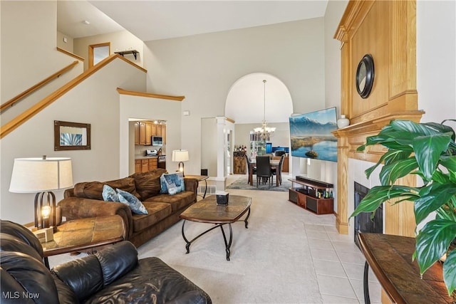 957 Devonwood Dr, Wadsworth, OH 44281 - living room with a chandelier, light tile patterned flooring, a fireplace, light colored carpet, and a towering ceiling