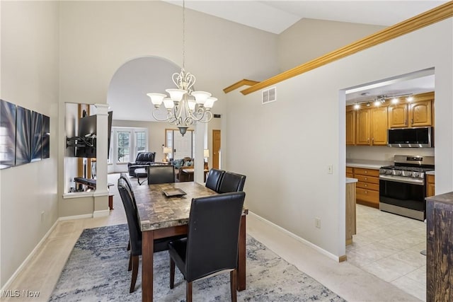 957 Devonwood Dr, Wadsworth, OH 44281 - dining room featuring arched walkways, a chandelier, and high vaulted ceiling