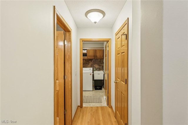 957 Devonwood Dr, Wadsworth, OH 44281 - hallway featuring light wood-style flooring and independent washer and dryer