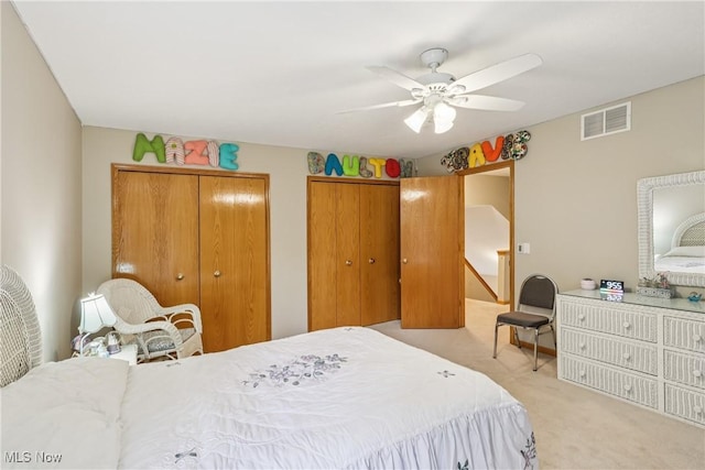 957 Devonwood Dr, Wadsworth, OH 44281 - bedroom with light carpet, two closets, and ceiling fan