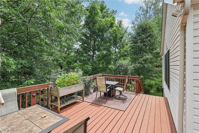 957 Devonwood Dr, Wadsworth, OH 44281 - wooden deck featuring outdoor dining area and view of wooded area