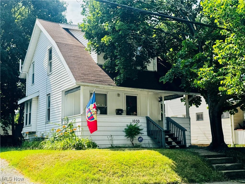 1030 Pitkin Ave, Akron, OH 44310 - view of front of house featuring a front yard, board and batten siding, and a shingled roof