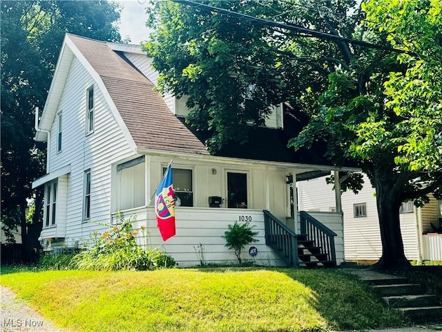 1030 Pitkin Ave, Akron, OH 44310 - view of front of house featuring a front yard, board and batten siding, and a shingled roof