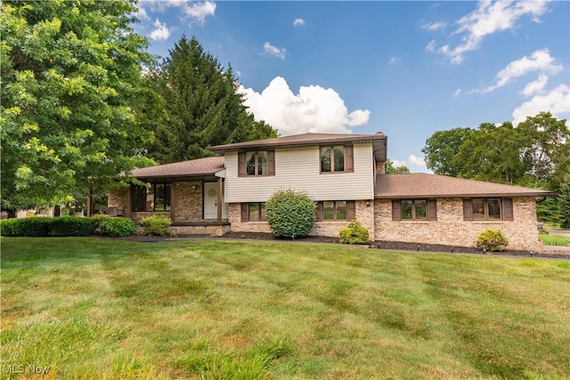 5200 Tanglewood Ave NE, Louisville, OH 44641 - tri-level home featuring a front lawn, a porch, and brick siding