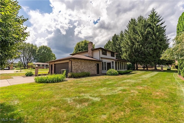 5200 Tanglewood Ave NE, Louisville, OH 44641 - view of side of property featuring concrete driveway, a garage, a lawn, a chimney, and brick siding