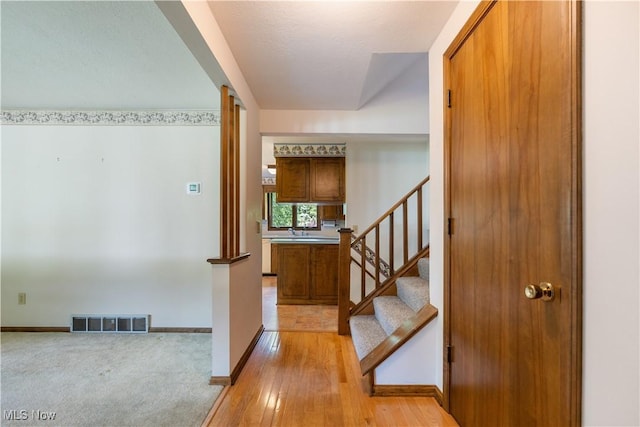 5200 Tanglewood Ave NE, Louisville, OH 44641 - foyer with stairs and light wood-style floors