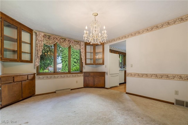 5200 Tanglewood Ave NE, Louisville, OH 44641 - unfurnished dining area featuring a chandelier and light carpet