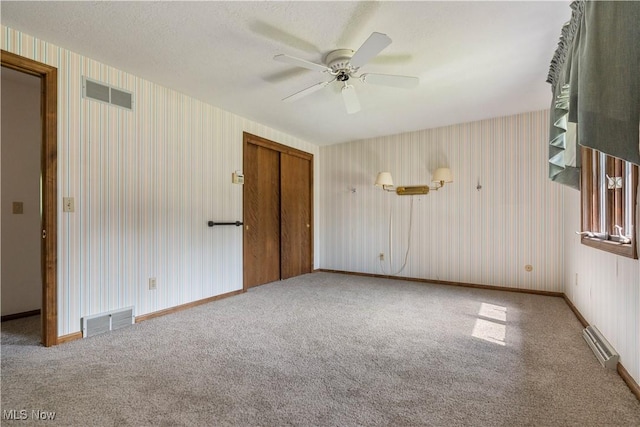 5200 Tanglewood Ave NE, Louisville, OH 44641 - carpeted empty room featuring wallpapered walls and a ceiling fan
