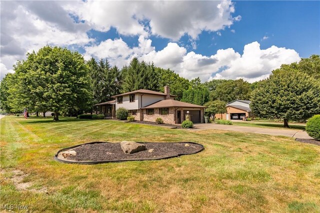 5200 Tanglewood Ave NE, Louisville, OH 44641 - view of grassy yard featuring concrete driveway and a garage